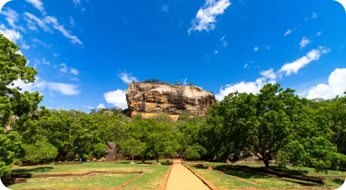 Sigiriya Rock Fortress rising above lush greenery in Sri Lanka