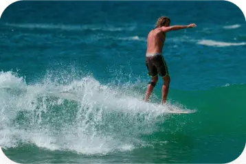 A man surfing on a wave in Sri Lanka