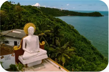 Large Buddha statue on a hilltop overlooking the ocean in Sri Lanka